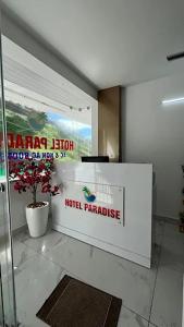 a lobby with a hotel paradise sign on the wall at Hotel Paradise Kovalam in Trivandrum