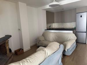 a living room with a couch and a kitchen at Arroyo Alpujarra in Guarros