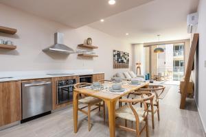 a kitchen with a wooden table and chairs at Las Arenas de Cabo in Cabo San Lucas
