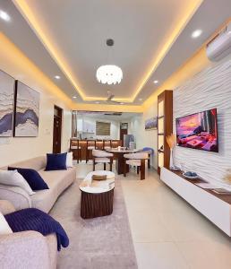 a living room with a couch and a tv at Luxury Beachfront apartment at Baobab Waves in Mombasa