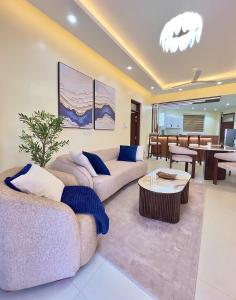 a living room with two couches and a table at Luxury Beachfront apartment at Baobab Waves in Mombasa