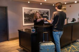 a man and a woman standing at a cash register at Hampton Inn & Suites Spokane Valley in Spokane Valley +34 photos