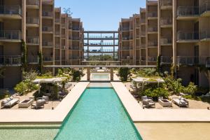 an image of a swimming pool in the middle of a building at Las Arenas de Cabo in Cabo San Lucas