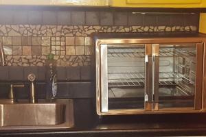a toaster oven sitting on top of a kitchen counter at The Red Rooster Bungalow in Asheville +49 photos