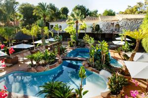 an aerial view of a resort pool with tables and umbrellas at SWISS MORAIRA HOTEL - Adults only in Moraira