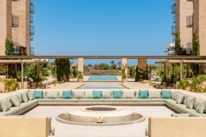 a patio with a couch and a fire pit at Las Arenas de Cabo in Cabo San Lucas