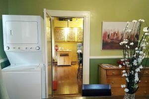 a kitchen with a refrigerator and a dining room at The Red Rooster Bungalow in Asheville