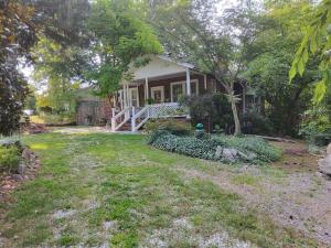 a small house with a yard in front of it at The Red Rooster Bungalow in Asheville