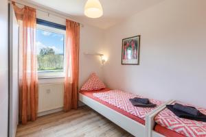 a small bedroom with a bed and a window at Ferienwohnung Waldeck am Edersee in Waldeck
