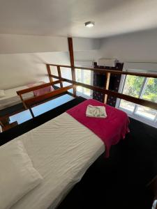 a bedroom with a bed with a red blanket at DM Thermas Hotel Iraí in Iraí