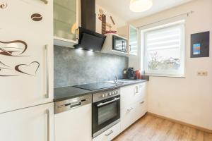 a kitchen with a sink and a stove at Ferienwohnung Waldeck am Edersee in Waldeck +7 photos