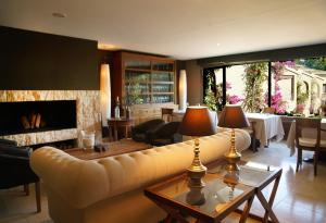 a living room with a couch and a fireplace at SWISS MORAIRA HOTEL - Adults only in Moraira