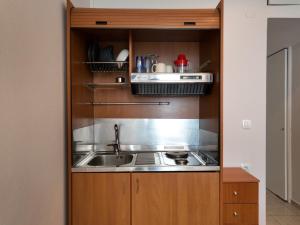 a kitchen with a sink and a stove at Captain's Tolo Sea View 2 in Tolo