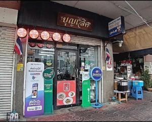a store with signs on the front of it at Boonlert Egg Noodle in Bangkok