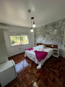 a bedroom with a large bed and a window at DM Thermas Hotel Iraí in Iraí