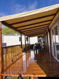 a wooden deck with awning on a house at Camping siblu in Lattes