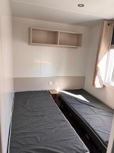 an empty room with a bed and a window at Camping siblu in Lattes