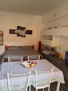 a bedroom with a bed and a table and chairs at Casa Smile in Legnano