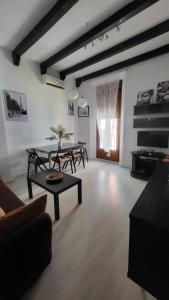 a living room with a table and chairs and a piano at Cádiz Playa La Caleta Terraza con Barbacoa in Cádiz +22 photos