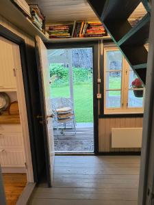 an open door to a porch with a chair outside at Flintegården Kårhus in Borgund