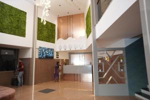 a lobby with people standing in a building at South Forest Wayanad By Bestinn Leisure in Sultan Bathery