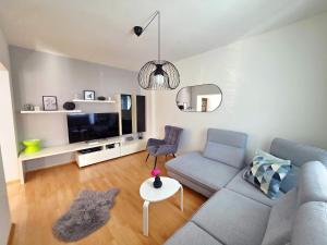 a living room with a couch and a tv at Apartma Katarina's place in Bovec