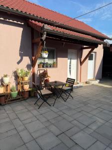 a patio with chairs and a table in front of a house at MM Studio in Donji Miholjac