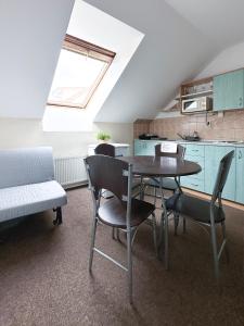 a kitchen and dining room with a table and chairs at Apartmány Žalák in Ostrava