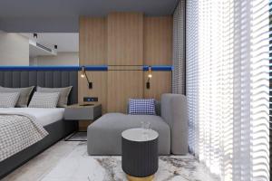 a bedroom with a bed and a couch and a table at Almaris Resort in Alanya +29 photos