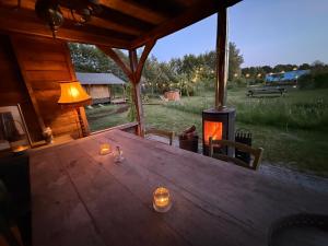 a wooden table with a lamp and a wood stove at The Love Nest in Heelweg