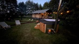a yurt with a table and chairs in a yard at night at The Love Nest in Heelweg