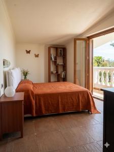 a bedroom with a bed and a large window at Residence Martina in Marina di Camerota