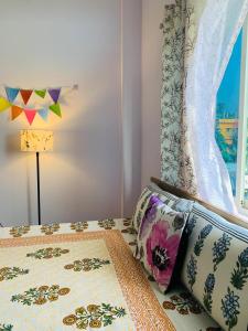 a bedroom with a bed with a pillow and a window at Windchime 9 in Guwahati