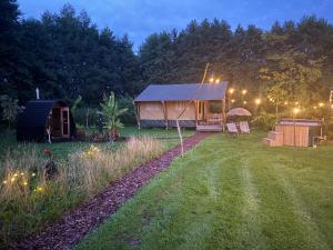 a tent in a yard at night with a yard at The Love Nest in Heelweg +17 photos