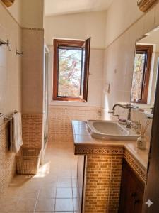 a bathroom with a sink and a window at Residence Martina in Marina di Camerota +41 photos