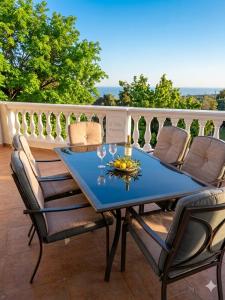 a table with glasses and a bowl of fruit on a balcony at Residence Martina in Marina di Camerota