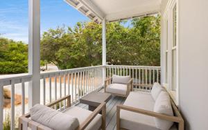 a balcony with two chairs and a table at Ritz Clareon by Oversee 30A in Seacrest