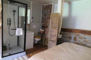 a bedroom with a bathroom with a shower and a toilet at La maison de Barbara in Aubel