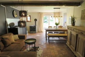 a living room with a couch and a table at La maison de Barbara in Aubel