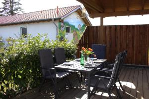 a table with chairs and flowers on a patio at Weserberglandalm in Ottenstein