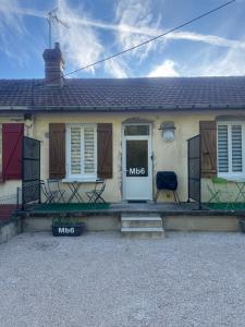 a white house with a door with the word music on it at Les Cerisiers - Une escale comme à la maison - in Damparis