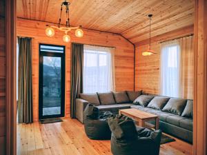 a living room with a couch and a table at Pinewood Surami in Surami