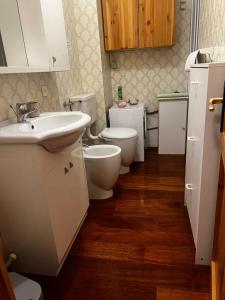 a bathroom with two toilets and a sink at Le Grenier Morgex La Ruine in Morgex +26 photos