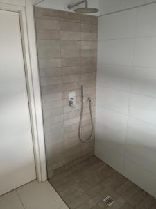 a shower with a hose in a bathroom at Villa Oikos in Syvota