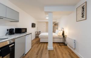 a kitchen and a bedroom with a bed in a room at 8 Stanley Street Apart-Hotel in Liverpool