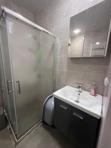 a bathroom with a shower and a sink at apartment in Itʼkhvisi