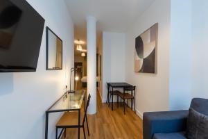 a living room with a blue couch and a table at 8 Stanley Street Apart-Hotel in Liverpool