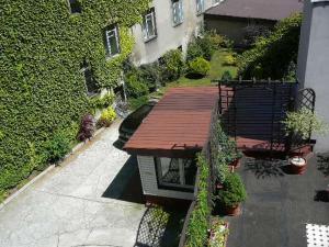 an overhead view of a wooden deck next to a building at Center Apartment in Przemyśl