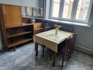 a dining room with a table and some chairs at Center Apartment in Przemyśl
