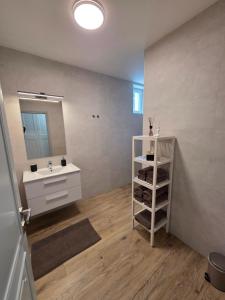 a bathroom with a sink and a mirror at Harmónia Apartmanház in Kőszeg +18 photos